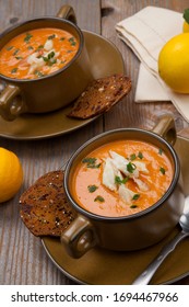 Hot Two Bowls Of Crab Bisque Garnished With Fresh Cooked Dungeness Crab Meat And Green Chives. Garnished With Whole Grain Crackers. Rustic Style.