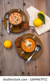 Hot Two Bowls Of Crab Bisque Garnished With Fresh Cooked Dungeness Crab Meat And Green Chives. Garnished With Whole Grain Crackers. Rustic Style.