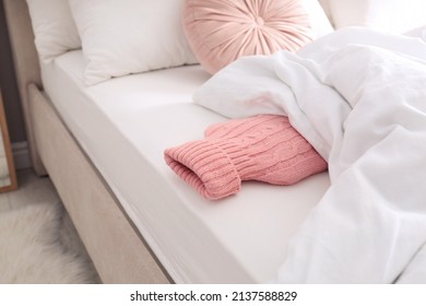 Hot Water Bottle With Knitted Cover In Bed Indoors