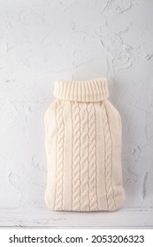 
Hot Water Bottle In A White Knitted Cover