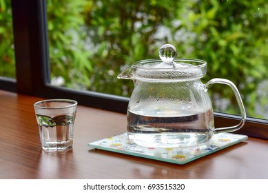 Hot Water In Glass Jug And Cup On Wood Table