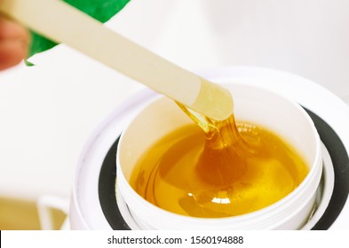 Hot wax in white bowl for hair removal - Shutterstock ID 1560194888