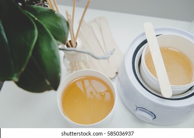 hot wax in white bowl for Hair removal - Shutterstock ID 585036937