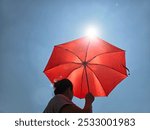 hot weather and temperatures in asia, woman with an umbrella under the hot sun in summer, long droughts and heat waves due to climate change.