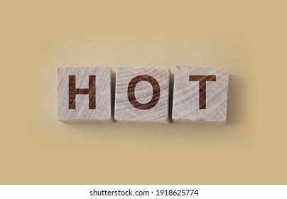 HOT Word Written On Wooden Blocks And Placed On A Yellow. Vacancy, Sale And Hot Seat Concept.