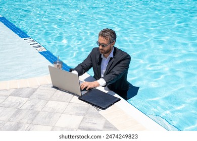 Hot working. Funny office worker. Business man in suit work online laptop in sea. Travel work and business concept. Crazy office employee work remote. Businessman on summer vacation distance work. - Powered by Shutterstock