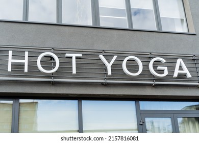 Hot Yoga Studio Sign, White Letters Yoga Class, Hot Workout, Stretching Room, Building Facade, Sports Section, Oriental Practices. High Quality Photo