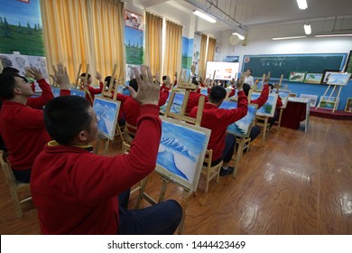 HOTAN, CHINA - APRIL 27 2019. Uighurs learn the profession of painter at reeducation camp (vocational skills training center) in Moyu County, Hotan Prefecture in Xinjiang.