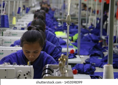 HOTAN, CHINA - APRIL 27 2019. Uigur Women Work In A Cloth Factory In Hotan County, Xinjiang Province, China.