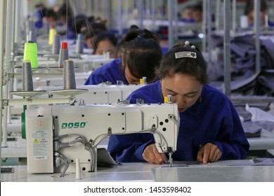 HOTAN, CHINA - APRIL 27 2019. Uigur Women Work In A Cloth Factory In Hotan County, Xinjiang Province, China.