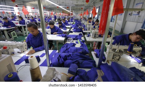 HOTAN, CHINA - APRIL 27 2019. Uigur Women Work In A Cloth Factory In Hotan County, Xinjiang Province, China.