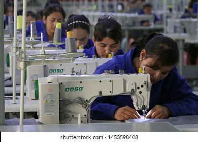 HOTAN, CHINA - APRIL 27 2019. Uigur Women Work In A Cloth Factory In Hotan County, Xinjiang Province, China.