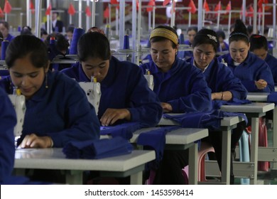 HOTAN, CHINA - APRIL 27 2019. Uigur Women Work In A Cloth Factory In Hotan County, Xinjiang Province, China.