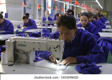 HOTAN, CHINA - APRIL 27 2019. Uigur Women Work In A Cloth Factory In Hotan County, Xinjiang Province, China.