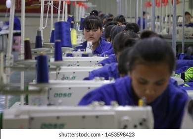 HOTAN, CHINA - APRIL 27 2019. Uigur Women Work In A Cloth Factory In Hotan County, Xinjiang Province, China.