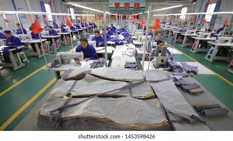 HOTAN, CHINA - APRIL 27 2019. Uigur Women Work In A Cloth Factory In Hotan County, Xinjiang Province, China.