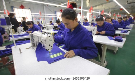 HOTAN, CHINA - APRIL 27 2019. Uigur Women Work In A Cloth Factory In Hotan County, Xinjiang Province, China.