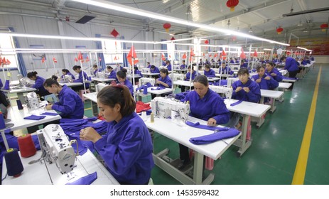 HOTAN, CHINA - APRIL 27 2019. Uigur Women Work In A Cloth Factory In Hotan County, Xinjiang Province, China.