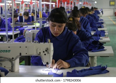 HOTAN, CHINA - APRIL 27 2019. Uigur Women Work In A Cloth Factory In Hotan County, Xinjiang Province, China.