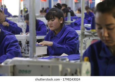 HOTAN, CHINA - APRIL 27 2019. Uigur Women Work In A Cloth Factory In Hotan County, Xinjiang Province, China.