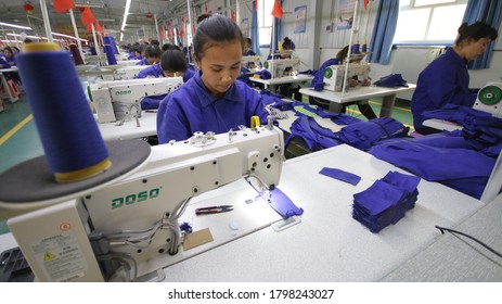 HOTAN, CHINA - APRIL 27 2019. Uigur Women Work In A Cloth Factory In Hotan County, Xinjiang Province, China.