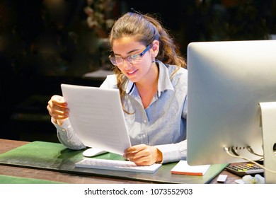 Hotel Administrator. A Woman-reception Worker Happy Lady, Enjoying The Good News In Writing. An Euphoric Girl Is Happy After Reading Good News In A Written Letter, Approving A Loan, Raising Her Job.