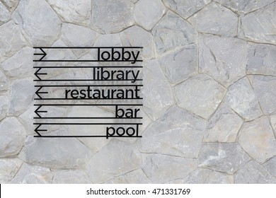 Hotel Arrow Signage On Stone Wall Background. Lobby, Library, Restaurant, Bar And Pool Sign.