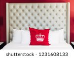 Hotel bed with red crown pillow case