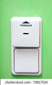 Hotel Card Holder On Green Wall And Light Switch