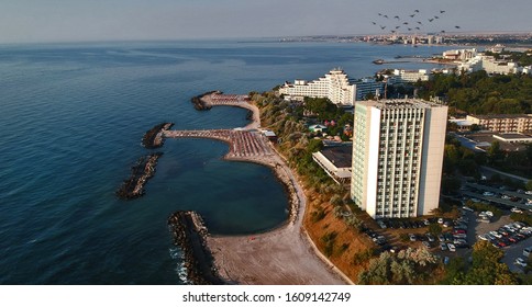 Hotel complex on the seafront. Many cars are parked around the hotel. Aerial view. On the Black Sea coast, in Romania, Jupiter Resort