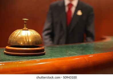 Hotel Concierge: Bell On The Reception Front Desk With Waiter