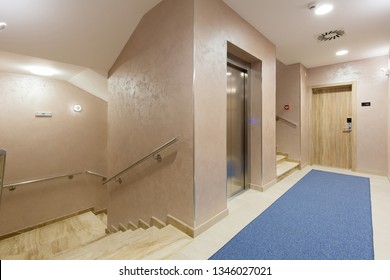 Hotel corridor with stairs and elevator - Shutterstock ID 1346027021
