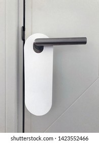 Hotel Door Handle With Blank White Paper Hanger. Do Not Disturb Mockup.