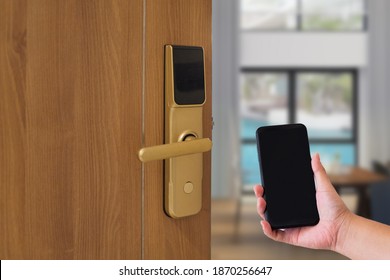 Hotel door security Unlocking by application on mobile phone. Digital door lock, keyless system of access door. Close up and selective focus.