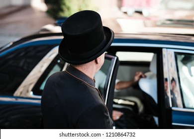 Hotel Doorman Opens Luxury Car Door For A Young Woman