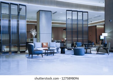 Hotel lobby interior with reception desk, marble floor and crystal lamp.