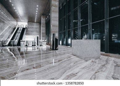 Hotel lobby interior with reception desk, sofas, marble floor and long bar.