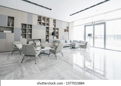 Hotel Lobby Interior With Reception Desk, Sofas, Marble Floor And Long Bar.