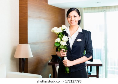 Hotel Manager Or Director Or Supervisor Welcome Arriving VIP Guests With Roses On Arrival In Luxury Or Grand Hotel