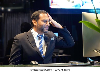 Hotel Manager. A Men-reception In Stress In Front Of A Computer. Poor Economy Concept. Bearded Man. Face Expression, Emotion Funny Face Expression Emotion Feelings Problem Perception Reaction, Stress