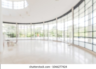 Hotel Or Office Building Lobby Blur Background Interior View Toward Reception Hall, Modern Luxury White Room Space With Blurry Corridor And Building Glass Wall Window