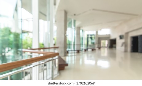 Hotel Or Office Building Lobby Blur Background Interior View Toward Reception Hall, Modern Luxury White Room Space With Blurry Corridor And Building Glass Wall Window