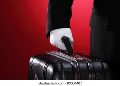 Hotel Porter Carrying Suitcase, Close Up, Side View