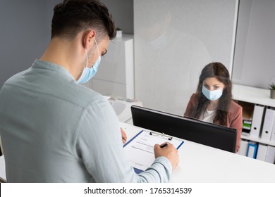 Hotel Reception Desk Protected By Medical Mask From Covid 19