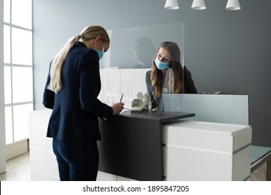 Hotel Reception Desk Protected By Medical Mask From Covid 19