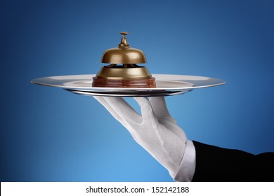 Hotel reception service bell on a silver tray concept for assistance and support