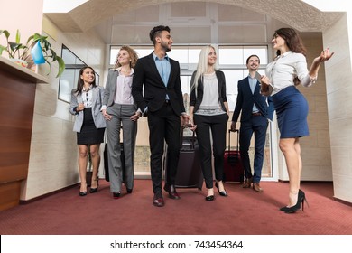 Hotel Receptionist Meeting Business People Group In Lobby, Guests Arrive