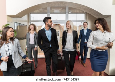 Hotel Receptionist Meeting Business People Group In Lobby, Guests Arrive