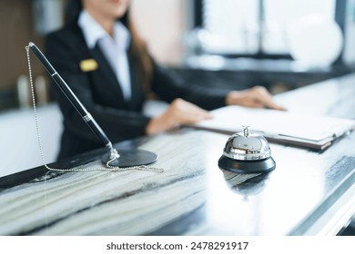 Hotel receptionist in uniforms at desk in lobby Friendly and welcome staff in hotel reception counter. - Powered by Shutterstock