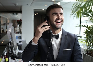 Hotel Receptionist Using Land Line Telephone